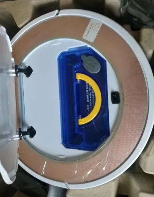 opening robot vacuum tank blue water